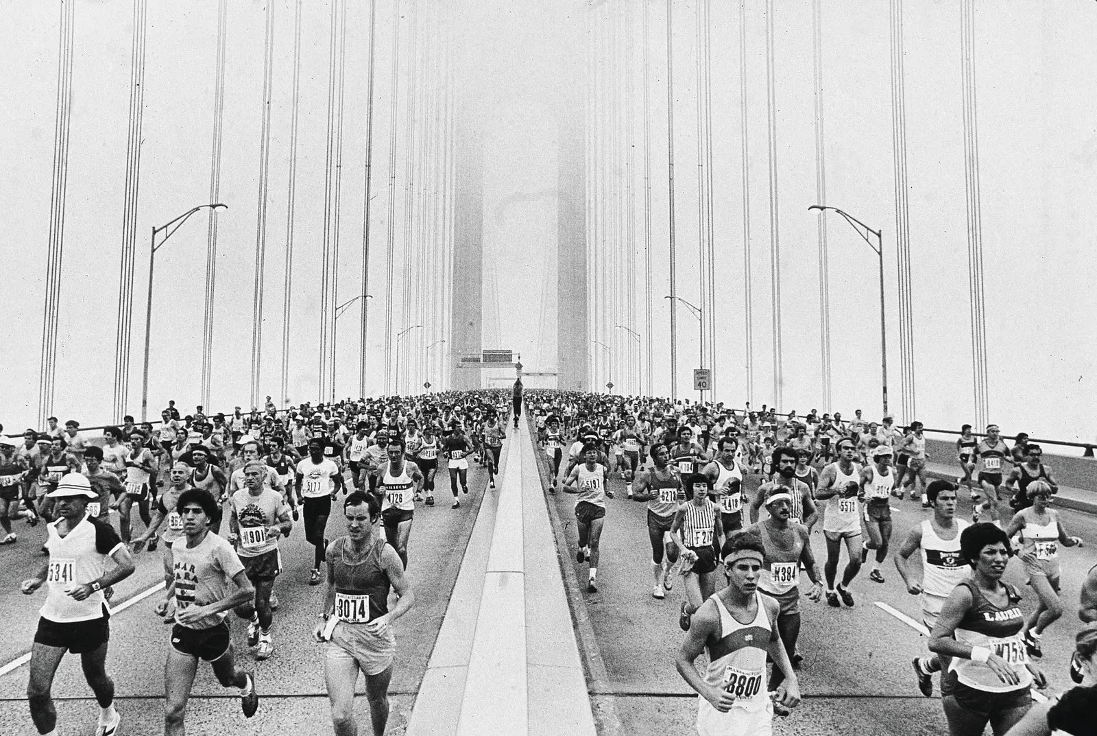 Marathon field crossing a bridge