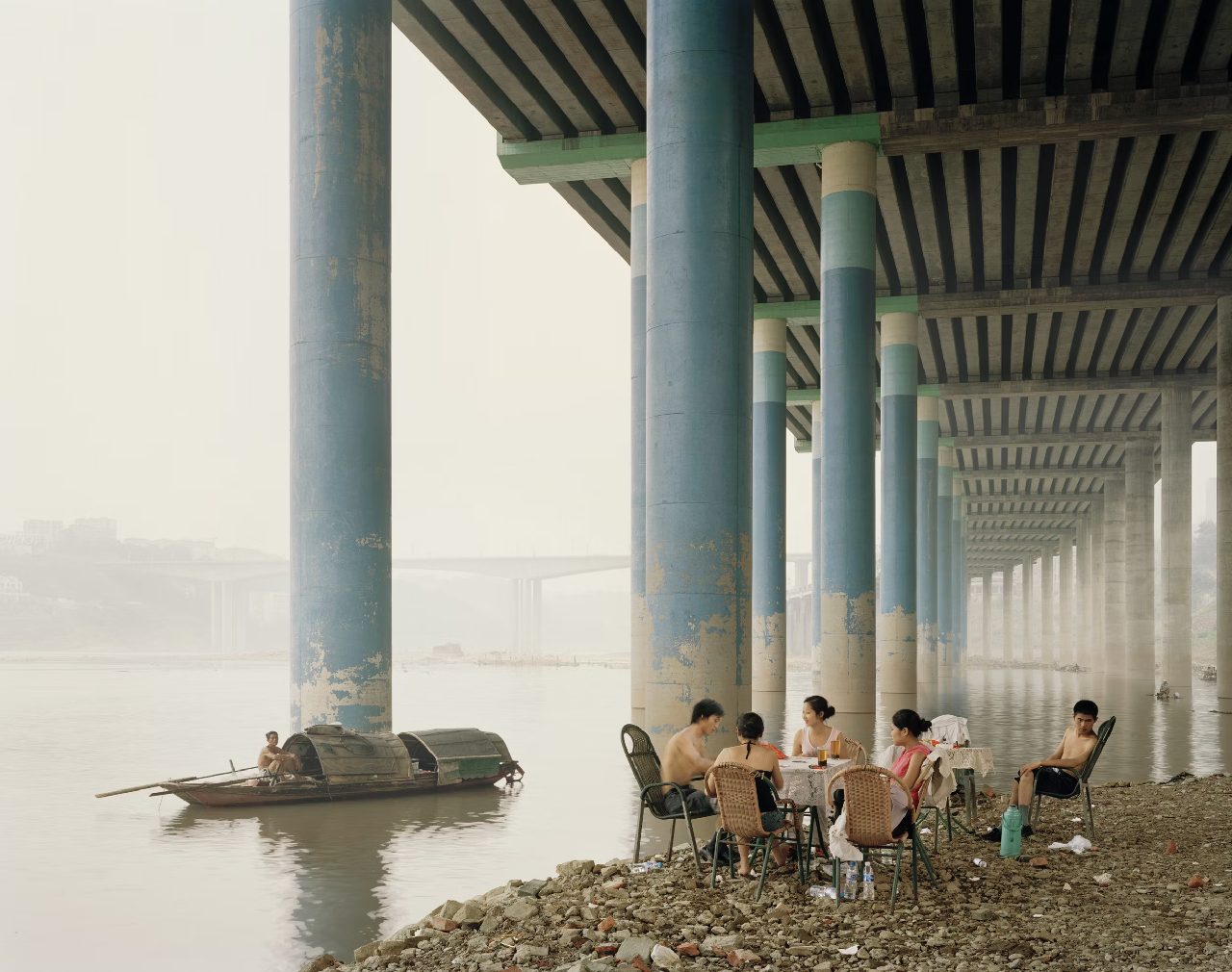 Under a bridge, by the river