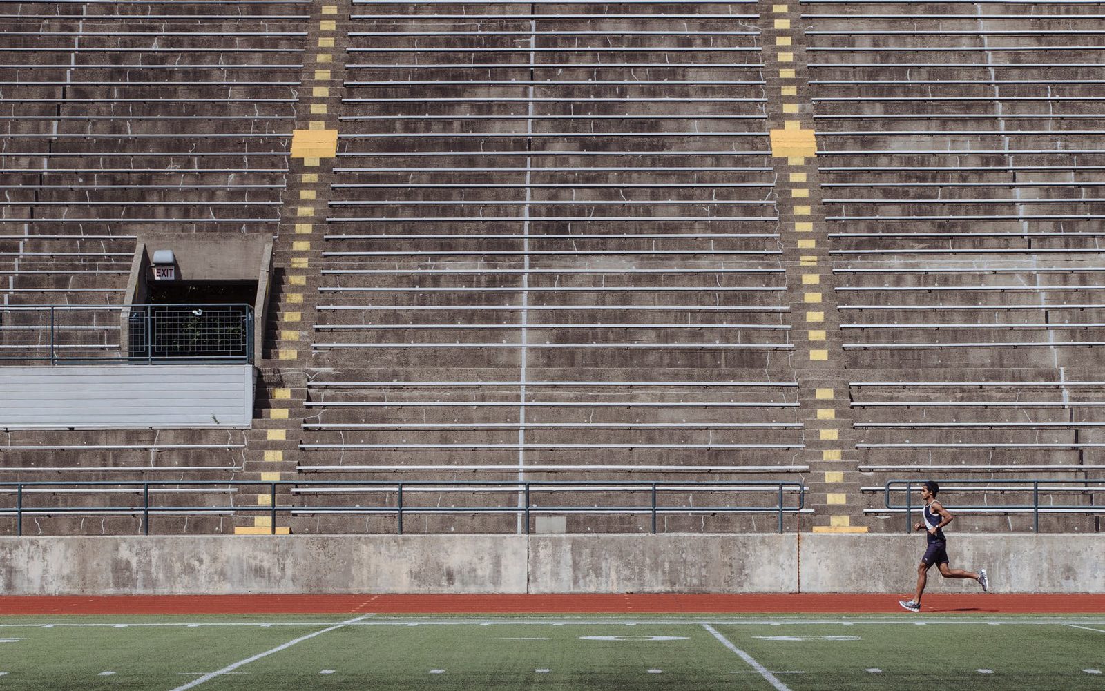 Runner on an empty track, college stadium