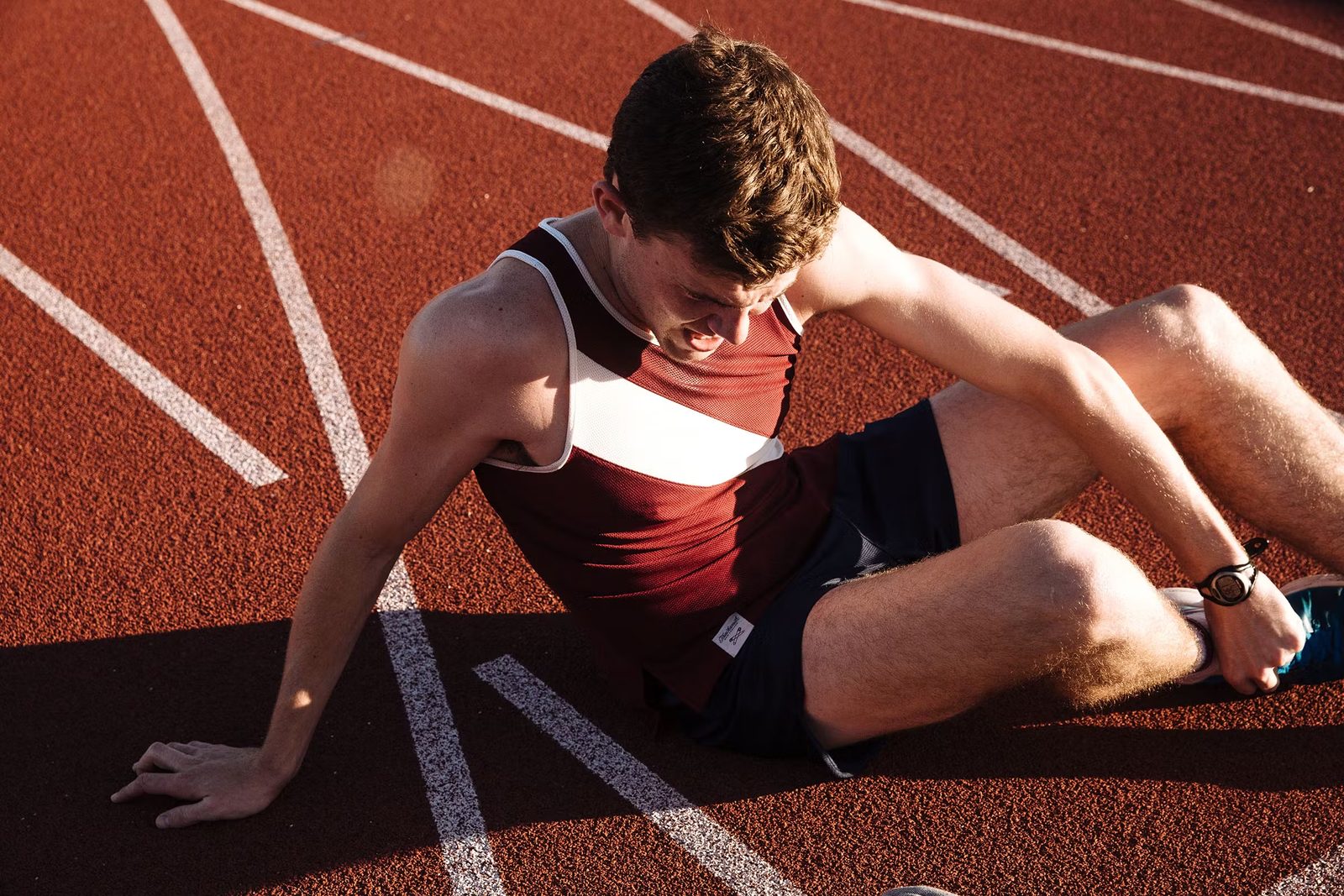 Runner sitting on the track after a race