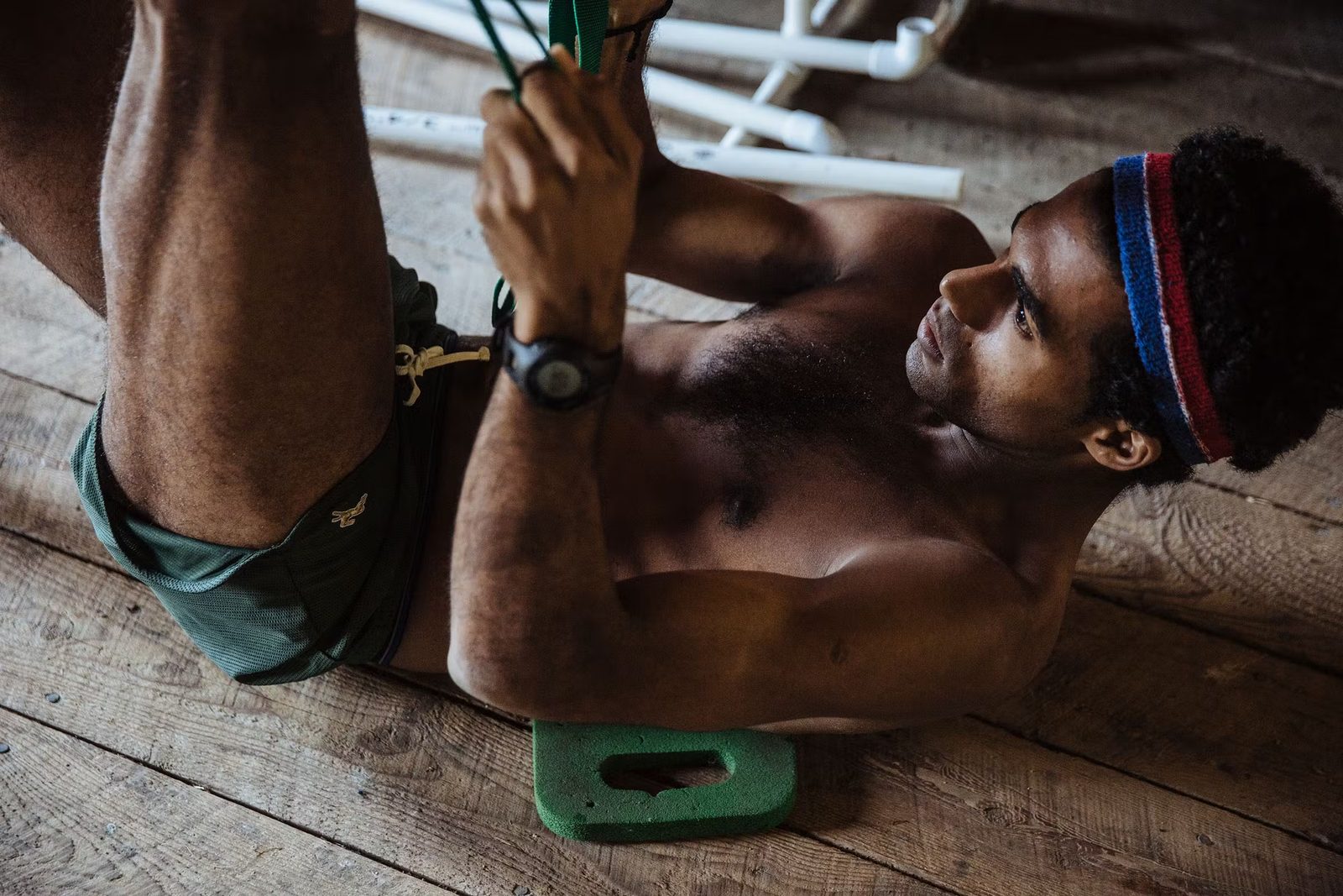 Runner tying a shoe in a locker room
